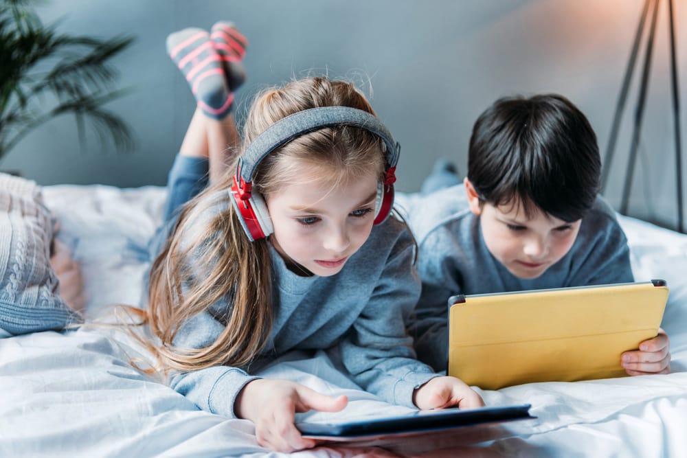 Sibling using Mobile and tablets under UAE Child Digital Safety Law