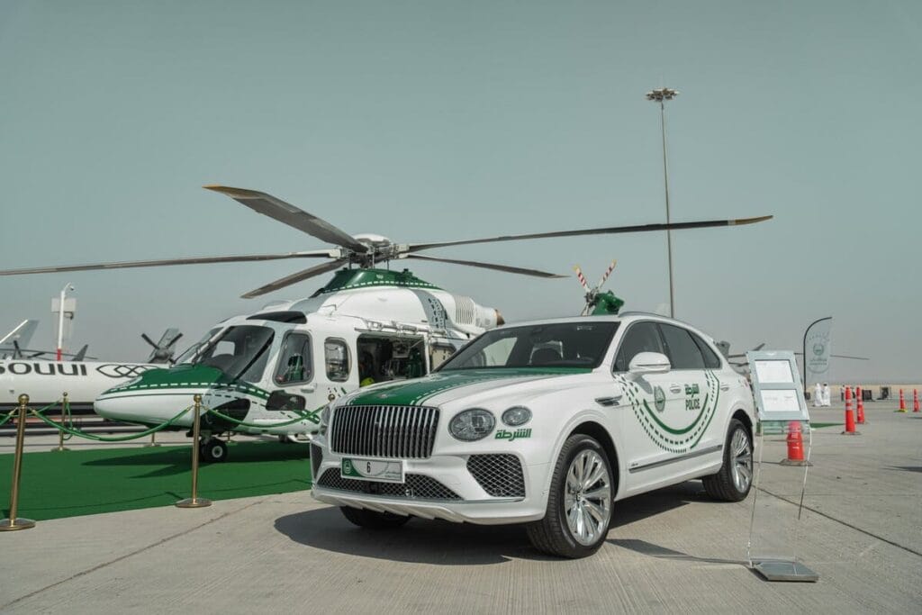 Dubai Police travel ban service check online - Police car and police chopper at Dubai Airport
