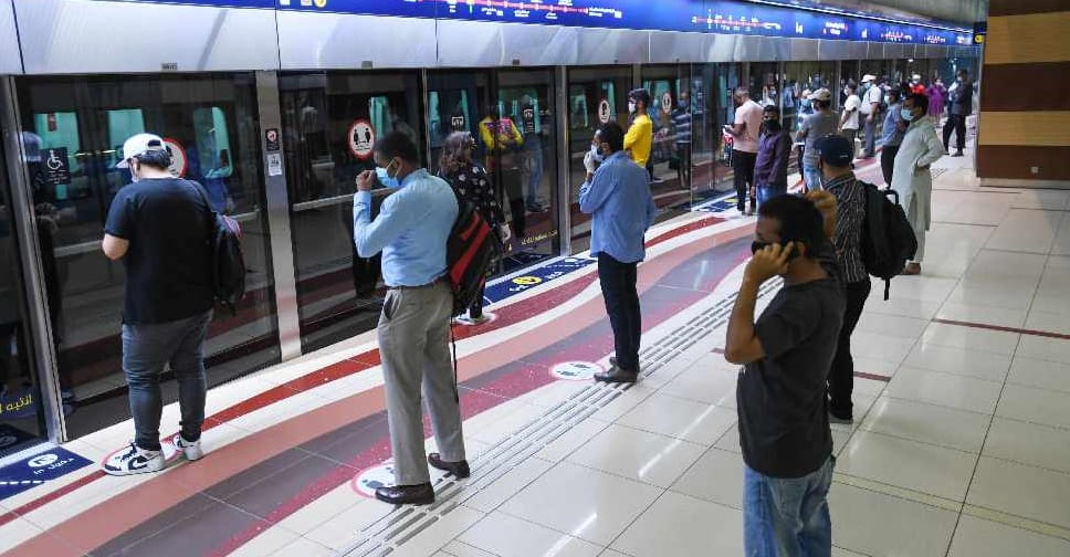 Commuters on Dubai Metro wearing face masks to prevent UAE winter flu transmission.