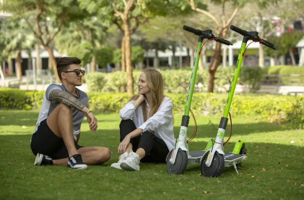 Cyclist explaining safety rules and helmet requirements for E-Scooter in UAE.