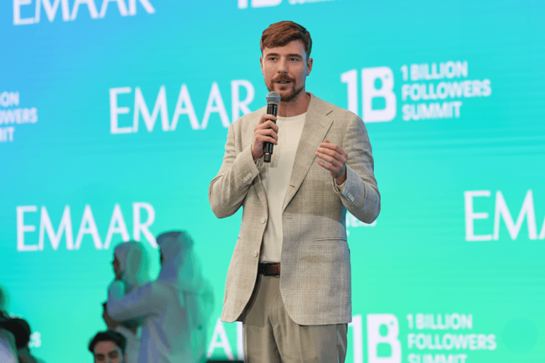 MrBeast speaking on stage about the 1 Billion Acts of Kindness campaign at the Dubai summit.