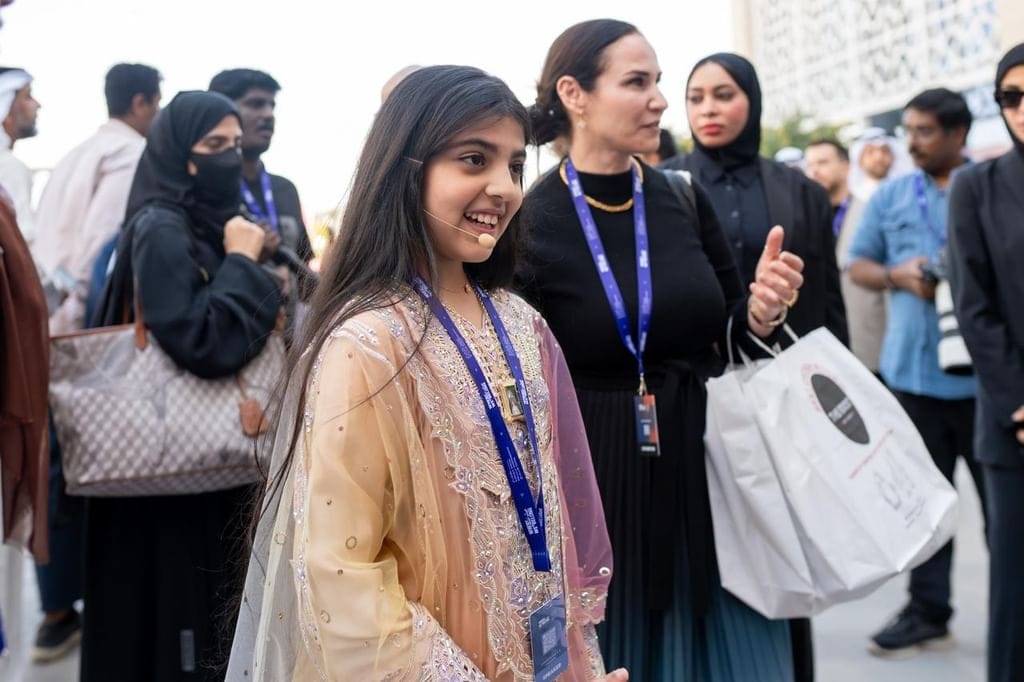 A young girl presenting her startup concept to judges at SEF 2026.