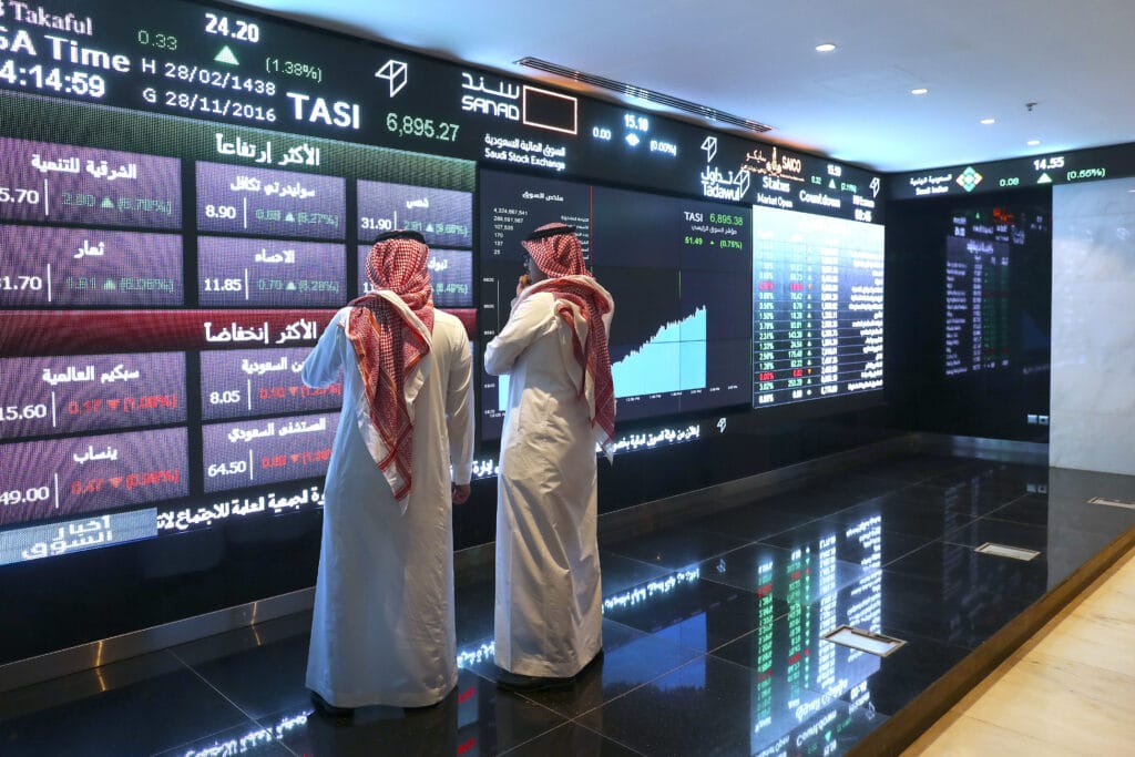 Traders watching screens at Tadawul during the Saudi Capital Market opening announcement.