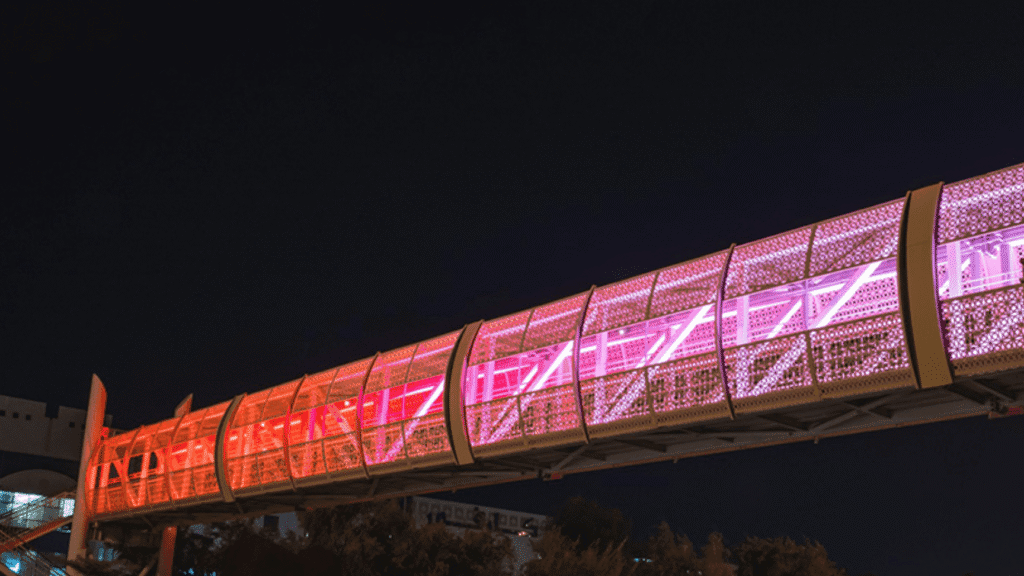 Aerial shot of a pedestrian bridge with smart lighting Abu Dhabi bridges for enhanced safety.