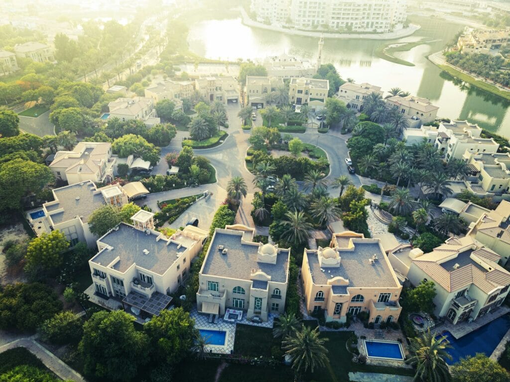 Dubai skyline viewed from a residential balcony with a tenant holding a formal rental contract.