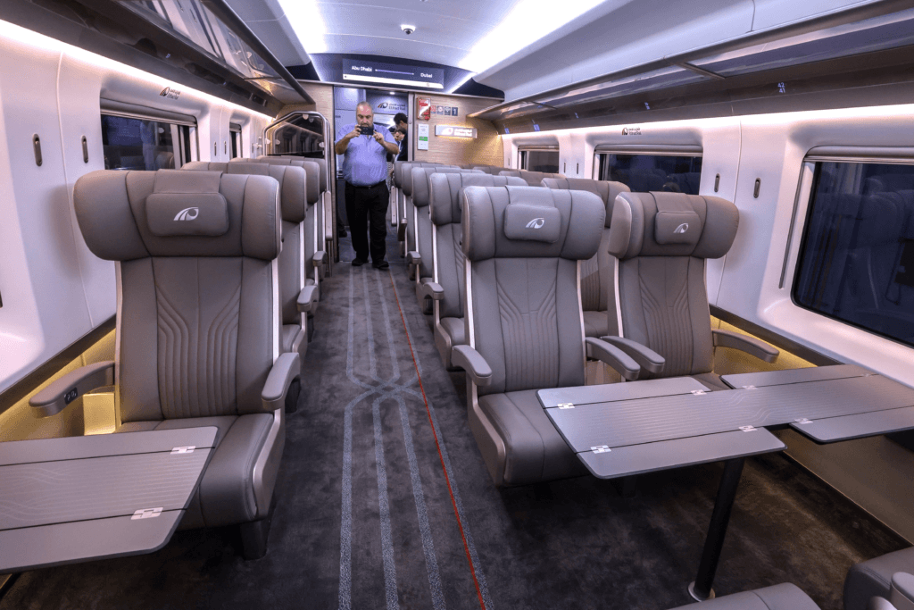 Interior of an Etihad Rail passenger train showing modern seating and onboard facilities